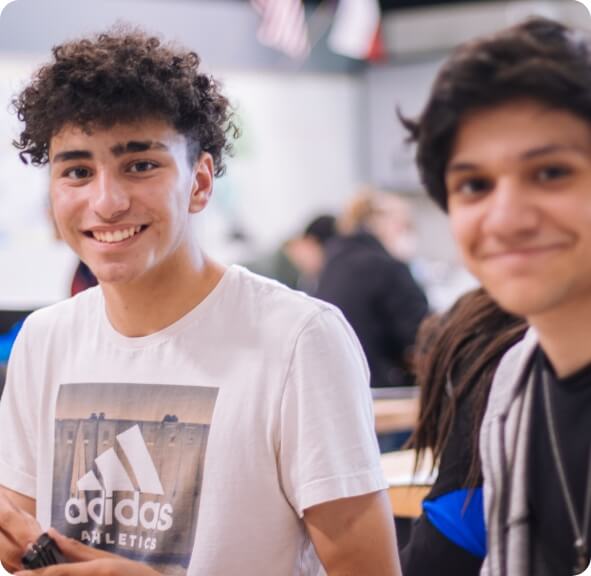 two male students smiling at the camera